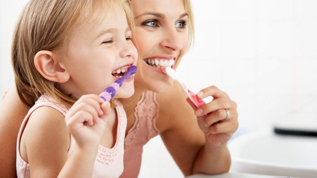 Mother and Daughter Brushing Teeth