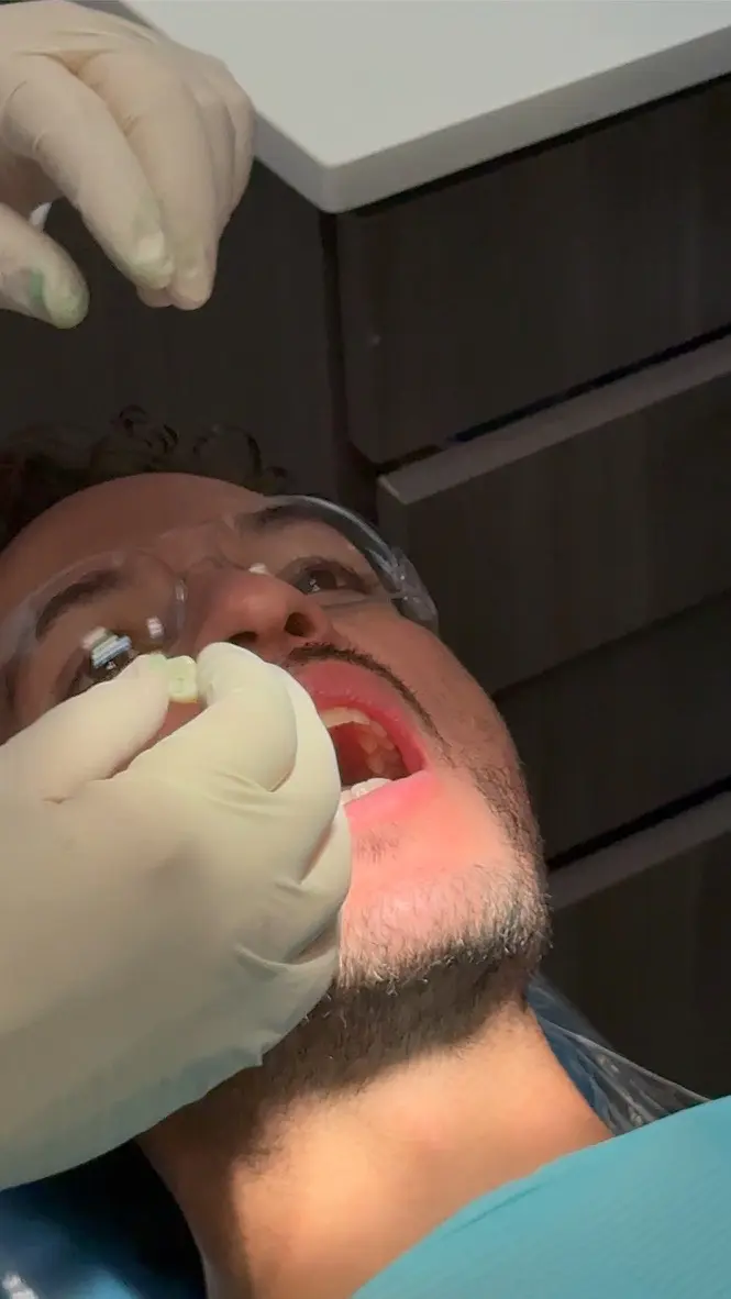 Dentist performing a dental examination or treatment on a patient at Florida Smiles Dental